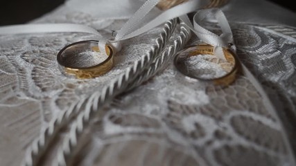 Wedding rings on a white cushion