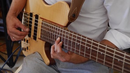 Man playing the six-string bass