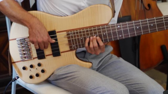 Man playing the six-string bass