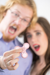 Couple playing with fidget spinner
