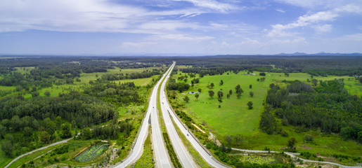 Aerial panorama of highway passing through countryside on bright sunny day. Collombatti, New South...