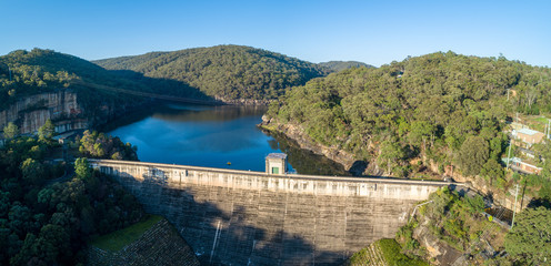 Obraz na płótnie Canvas Aerial panorama of Nepean Dam wall and lake Nepean at sunrise. Bargo, New South Wales, Australia