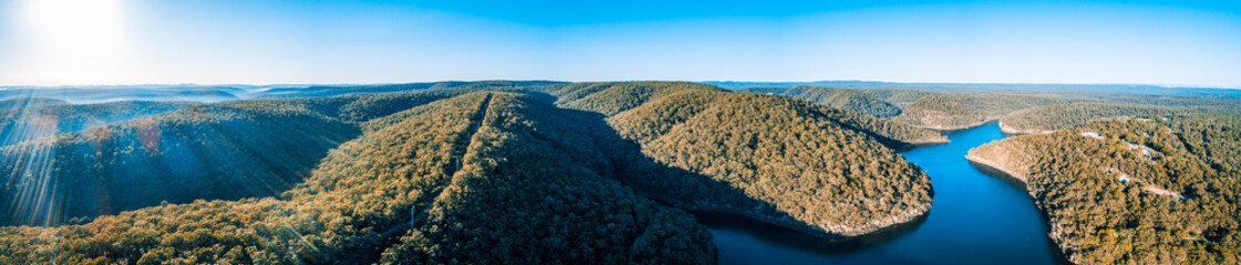 Wide aerial panorama of Lake Nepean and beautiful forested hills under clear sky.