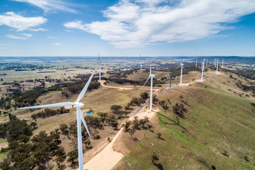 Aerial landscape of wind farm on a hill on bright sunny day in New South Wales, Australia