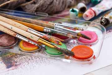 Paint brushes and paints for drawing.