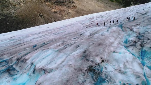 Fly over of a hike on a blue iced Alaskan glacier.