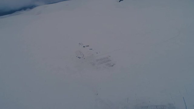 Aerial video of a dogsled camp on an Alaskan glacier.
