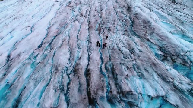 Fly out from a hike on a glacier to a full view of an Alaskan glacier.