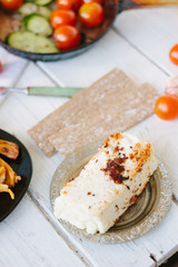 Roasted tofu - popular vegetarian cheese, in metal plate.
