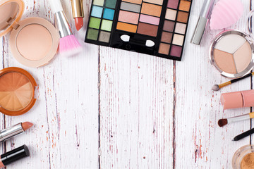 Makeup products on a wooden background