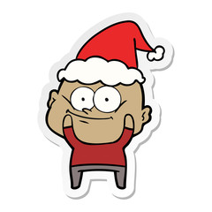 sticker cartoon of a bald man staring wearing santa hat