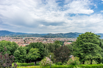 Italy,Florence, a large green field with trees in the background