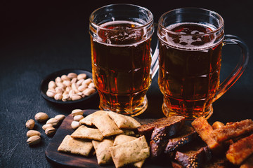 beer and snacks. bar table. restaurant, pub, food concept. craft lager drink, salted nuts and breaded fried cheese. friday party atmosphere, craft brewery background