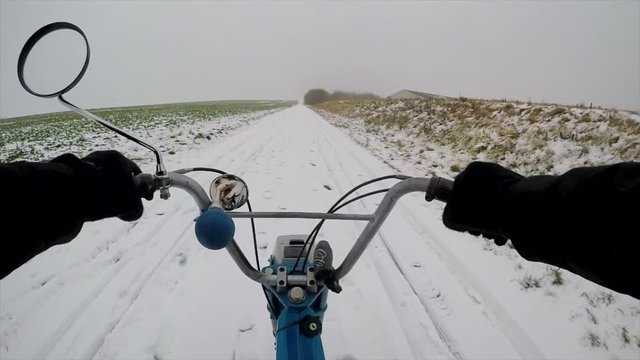 Driving a puch maxi in the snow. Slowmotion shot in 120p.
