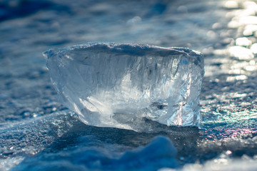 Pieces of clear blue ice of lake Baikal in the winter sunlight