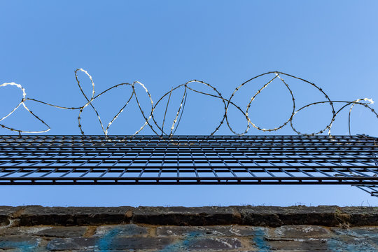 Barbed wire on blue sky background - Lost freedom and hope concept
