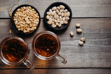 bar table. two mugs of lager beer and snacks set. restaurant, pub, food concept. delicious drink and salty nuts. oktoberfest atmosphere, craft brewery background