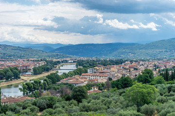 Fototapeta na wymiar Italy,Florence, a view of a city with a mountain in the background