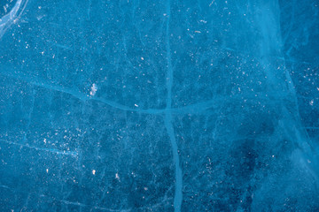 Texture of pure blue cracked ice of lake Baikal. Drawings of nature