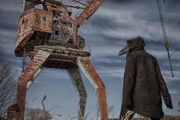 Man or wooman in leather pants, black hooded mantle and plague doctor (or raven) mask. Big rusty...