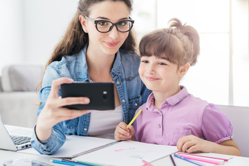 Girl and woman taking selfies with a smartphone