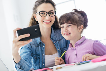Girl and woman taking selfies with a smartphone