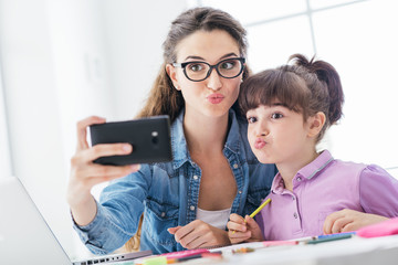 Girl and woman taking selfies with a smartphone