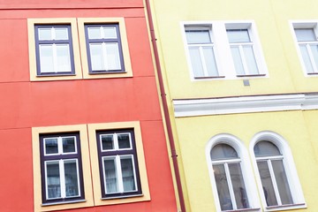 Fototapeta na wymiar Coral color and yellow facade of houses. Fragment, details. Prague, Czech Republic