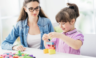 Teacher and child playing together