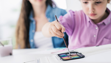 Mother and child painting at home
