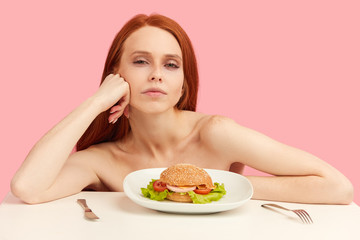 Excited red-haired skinny half naked woman in underwear, with greedy eyes being ready to eat...