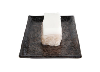 Thai pudding with coconut topping in black plate