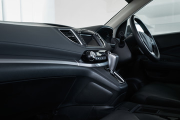 Fototapeta na wymiar Modern black car dashboard interior , luxury car interior concept . Side profile angle .