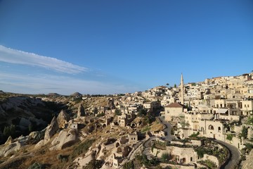 Fototapeta na wymiar View of ancient Nevsehir cave town and a castle of Uchisar dug from a mountains in Cappadocia, Central Anatolia,Turkey
