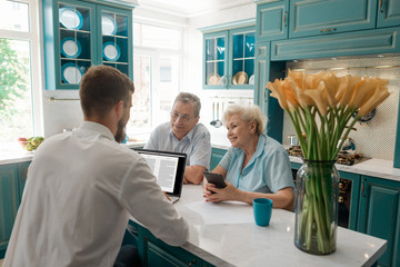 Retired couple talking with advisor