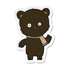 sticker of a cartoon waving black bear