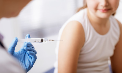 Doctor giving an injection to a young patient