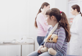 Cute girl with broken arm waiting to be visited