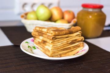 pancakes on a plate with honey and chocolate. stacked pyramid