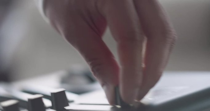 Someone playing around a synth piano keyboard.
