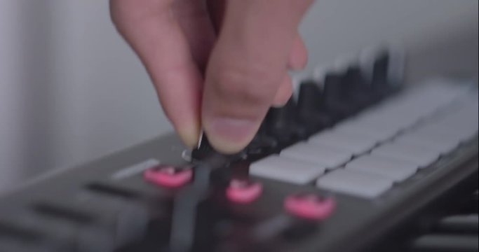 Someone playing around a synth piano keyboard.