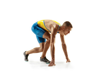 Young caucasian man preparing to run isolated on white studio background. One male runner or jogger. Silhouette of jogging athlete with shadows.