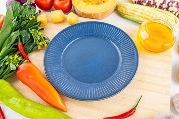 Fresh vegetables melons and empty saucers / nutrition concept background material