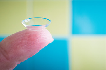 Contact lens on finger, close up.