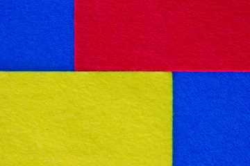Pieces of coloured felt. Red, yellow and  blue color composition. Colorful felt texture for background with copy space.