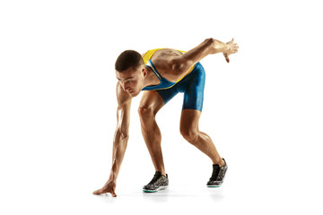 Young caucasian man running isolated on white studio background. One male runner or jogger....