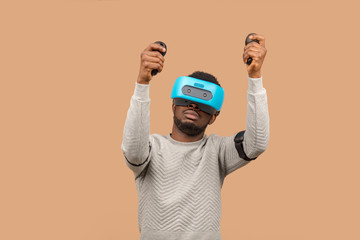 Virtual reality technology is constantly making huge advances. African casually dressed man trying...