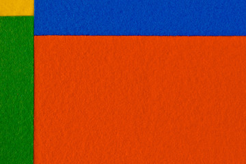 Pieces of coloured felt. Orange, yellow, green and  blue color composition. Colorful felt texture for background with copy space.