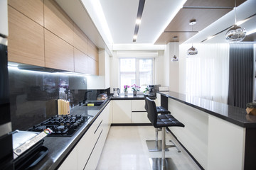 Dark brown modern kitchen interior in luxury home