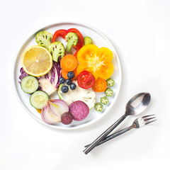 Flat lay colourful assorted vegan food slice and eating utensils on white background.